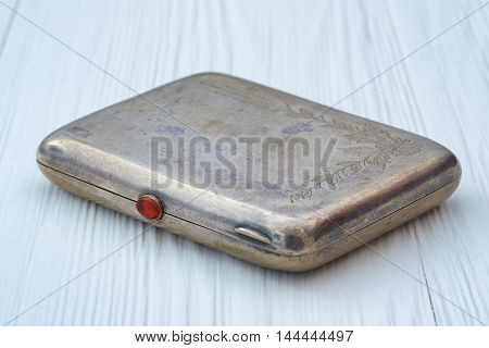Vintage metal cigarette case with an engraving on the lid