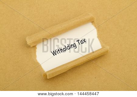Witholding Tax written under torn paper .