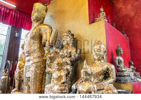 Old golden Buddha Statue (Bayon Style) with gold leaf.