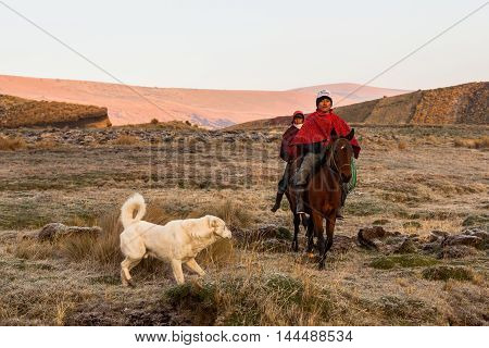 Ozogoche Ecuador December 19 2015: Unidentified Cowboys riding horses Ozogoche community looking for his cattle early morning