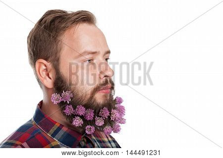 Portrait of handsome man with beard of clover flowers isolated on white