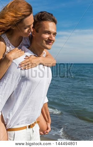 happy couple in love walking on the beach in summer white dress