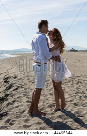 happy couple in love walking on the beach in summer white dress