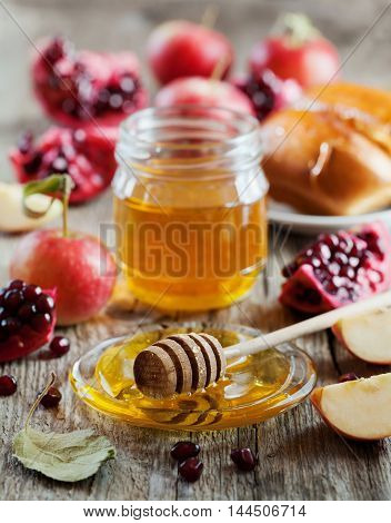 New Year Holiday Rosh Hashana traditional food: honey, apple, pomegranate and hala table set