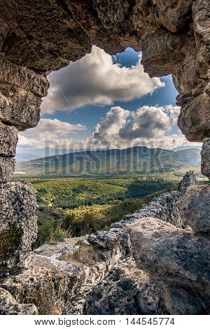 autumn landscape ruined ancient walls on a hill against the blue sky in Crimea.