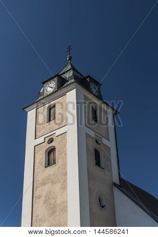 Big church tower in Kovarska village in summer evening
