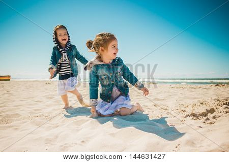 two little girls playing on the beach