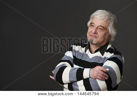 Portrait of handsome professor man of university or colleage posing with his arms crossed or folded isolated on black background in studio.