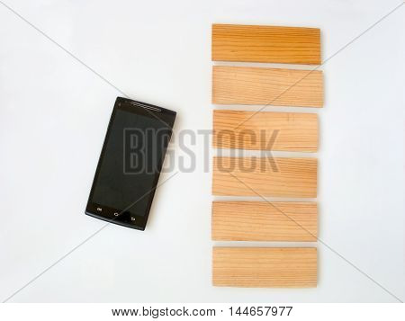 Phone on a white background. Near the wooden plank. White background can be any color and on tablets place my text.