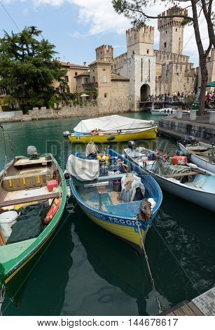 SIRMIONE ITALY - MAY 5 2016: Sirmione - Italian small city on Garda lake with boats and castle
