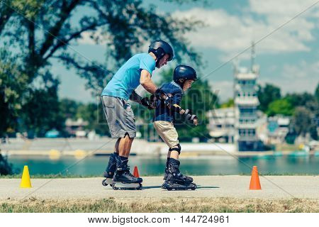 Roller skating class with senior teacher and little boy