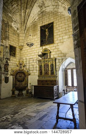 CUENCA SPAIN - August 24 2016: Interior of the Cathedral of Cuenca sacristy entrance of the higher sacristy the Auld mug in the center left an altar and on the right a Gothic window Cuenca heritage of humanity Spain
