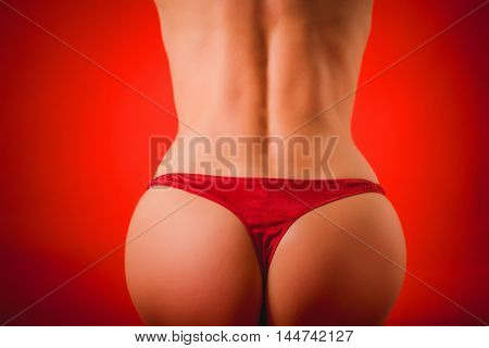 buttocks of a woman in red panties