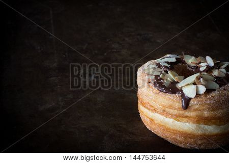 Cronus with Chocolate and Almonds on Rustic Background with Copy Space Horizontal