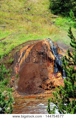 Heat and steam escapes from Chocolate Pot besides the Gibbon River in the Yellowstone National Park.