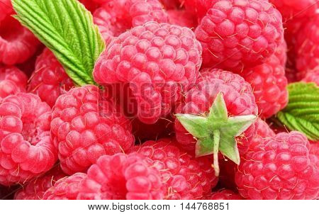 Raspberries with green leaves in the center