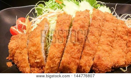 The Crispy Fried Pork With Vegetable In Black Plate, Tonkatsu , Japanese Food