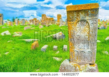 The carved patterns on the old khachkar with the cross crack in the middle of the stone block Noratus Cemetery Gegharkunik Province Armenia.