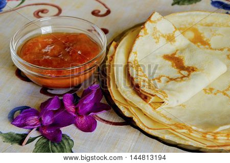 Delicious pancakes with jam on plate isolated