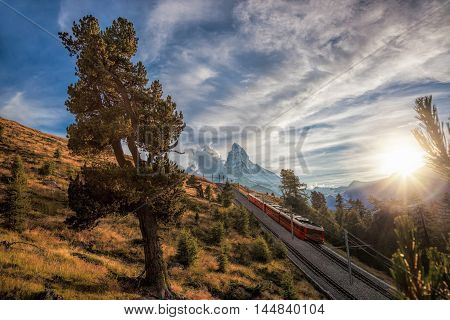 Matterhorn Peak With A Train Against Sunset In Swiss Alps, Switzerland