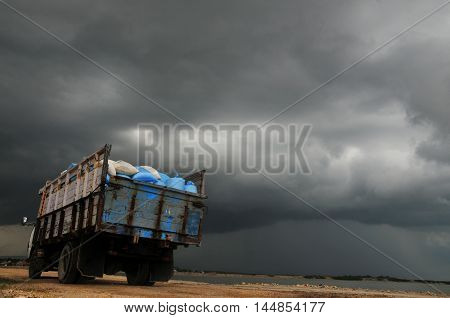 Bags of salt transported by an old truck passing through upcoming Storm in Pamekasan madura Indonesia