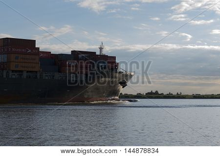 Hamburg, Germany - August 18, 2016: Container ship sails on the Elbe towards Hamburg harbor on August 18, 2016, in the Germany Hamburg