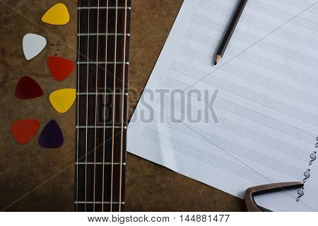 acoustic guitar pick and note selection focus.
