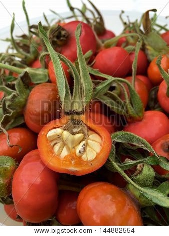 Rose hips on a white marble plate