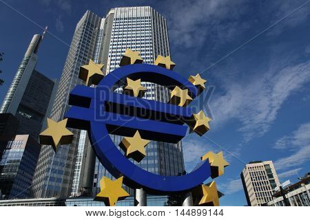 FRANKFURT AM MAIN, GERMANY - JUNE 14, 2015: Euro logo by German visual artist Ottmar Hoerl in front of the Eurotower in Frankfurt am Main, Hesse, Germany. 