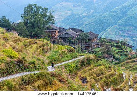 Longsheng China - October 19 2013: Traditional chinese Long Ji minority village wooden houses in cloudy weather. There are two Zhuang ethnic group villages live in the mountain - Ping An Village and Long Ji village at Longsheng Guangxi province China.