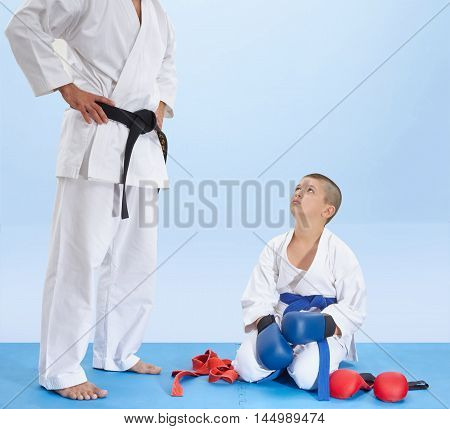 Athlete sitting on a mat listening to the instruction of coach