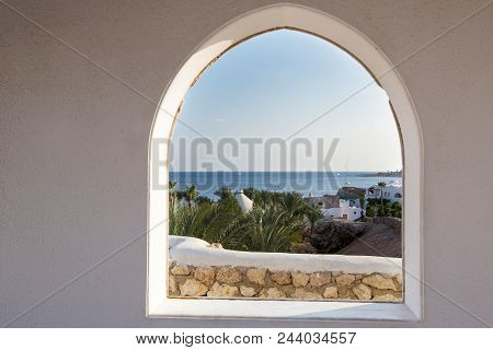 Egypt. A Look Through The Frame On The Palm Trees. Beautiful View. White House And Veranda Overlooki
