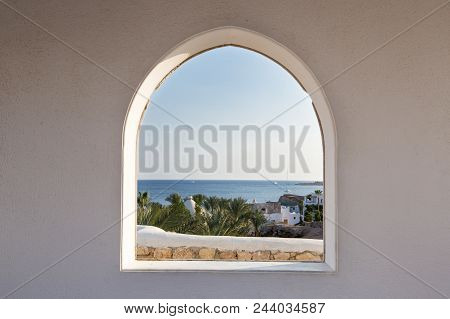 Egypt. A Look Through The Frame On The Palm Trees. Beautiful View. White House And Veranda Overlooki