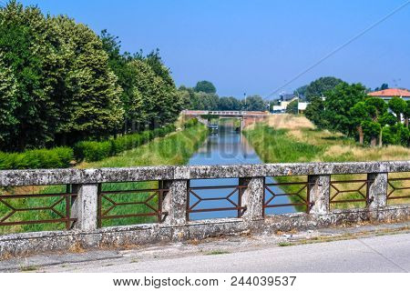 Rovigo, Italy - June, 5, 2018: bridge over a river in the vicinity of Rovigo, Italy