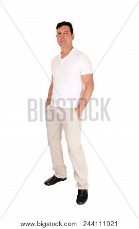 A Tall Handsome Middle Age Man Standing In A Beige Slacks And White
T-shirt With His Hands In His Po