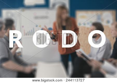 Team Leader Giving A Presentation On New Rodo Regulations In A Corporation. Blurred Photo With White