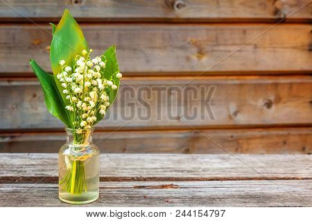 Bouquet Of Flowers Beautiful Smell Lily Of The Valley Or May-lily In Glass Vase On Rustic Old Vintag