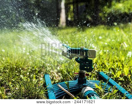 Close Up Garden Lawn  Irrigation System Sprinkers Splashes