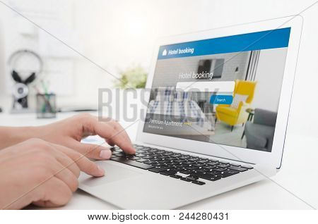 Person Booking Hotel Room On Laptop.