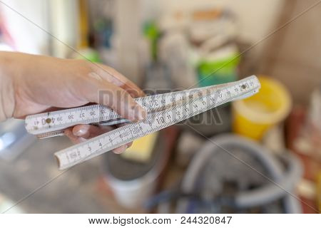Hand Holds A German Double Meter Stick On A Construction Site