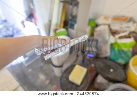 Hand Holds A German Double Meter Stick On A Construction Site