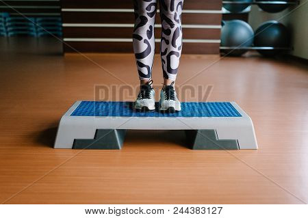 Young Fitness Girl In Sportswear And Shoes, Standing Legs On The Step Platform. Woman Feet On The Pl