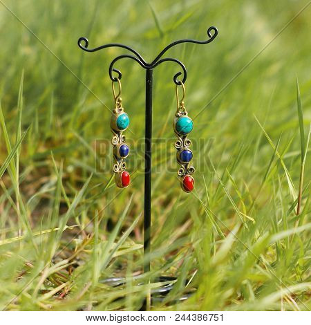 Earrings On Stand On The Green Grass