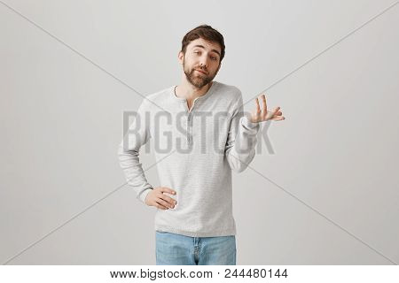 Unpleasant Caucasian Male Snob With Beard, Explaining Something While Gesturing With Hands, Making L