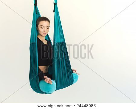 Happy Woman Practicing Fly Yoga In Lotus Asana, Sitting On Linen Over White Background In Fitness St