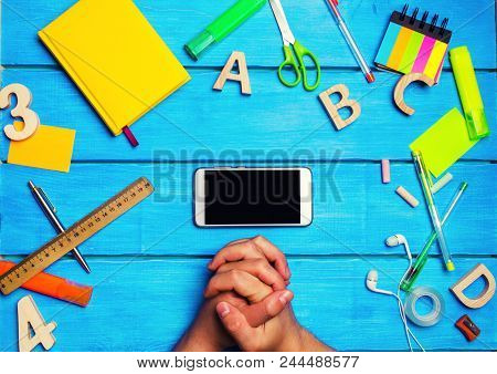 The Student Crossed His Hands In Front Of A Mobile Phone In The Workplace. A Place For Text. A Stude
