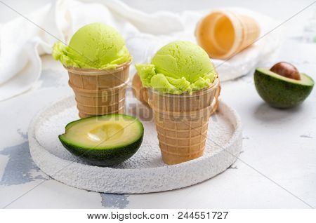 Green Avocado Ice Cream Scoops In Wafle Cones On White Background. Copy Space