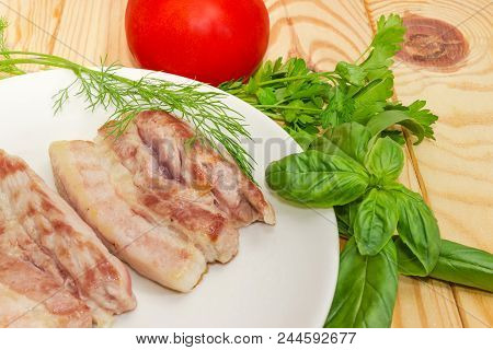 Fragment Of The White Dish With Slices Of The Grilled Streaky Bacon, Tomato And Different Greens Clo