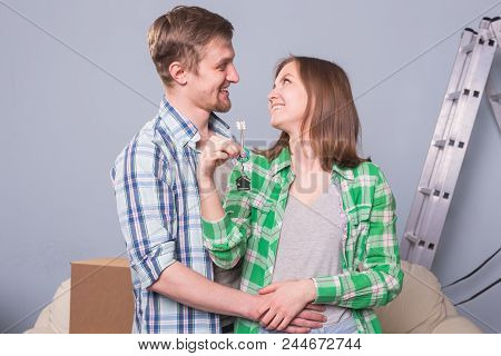 Happy Woman In Her New Home Holding Key