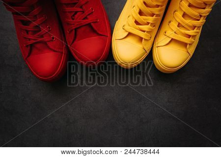 Young Adult People On A Love Date, Conceptual Image. Top View Of Two Pair Of Casual Sneakers From Ab